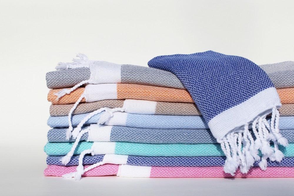 Ein Stapel mit verschiedenen Farben vom Hamamtuch Capri im Panamagewebe von Hamam Originals